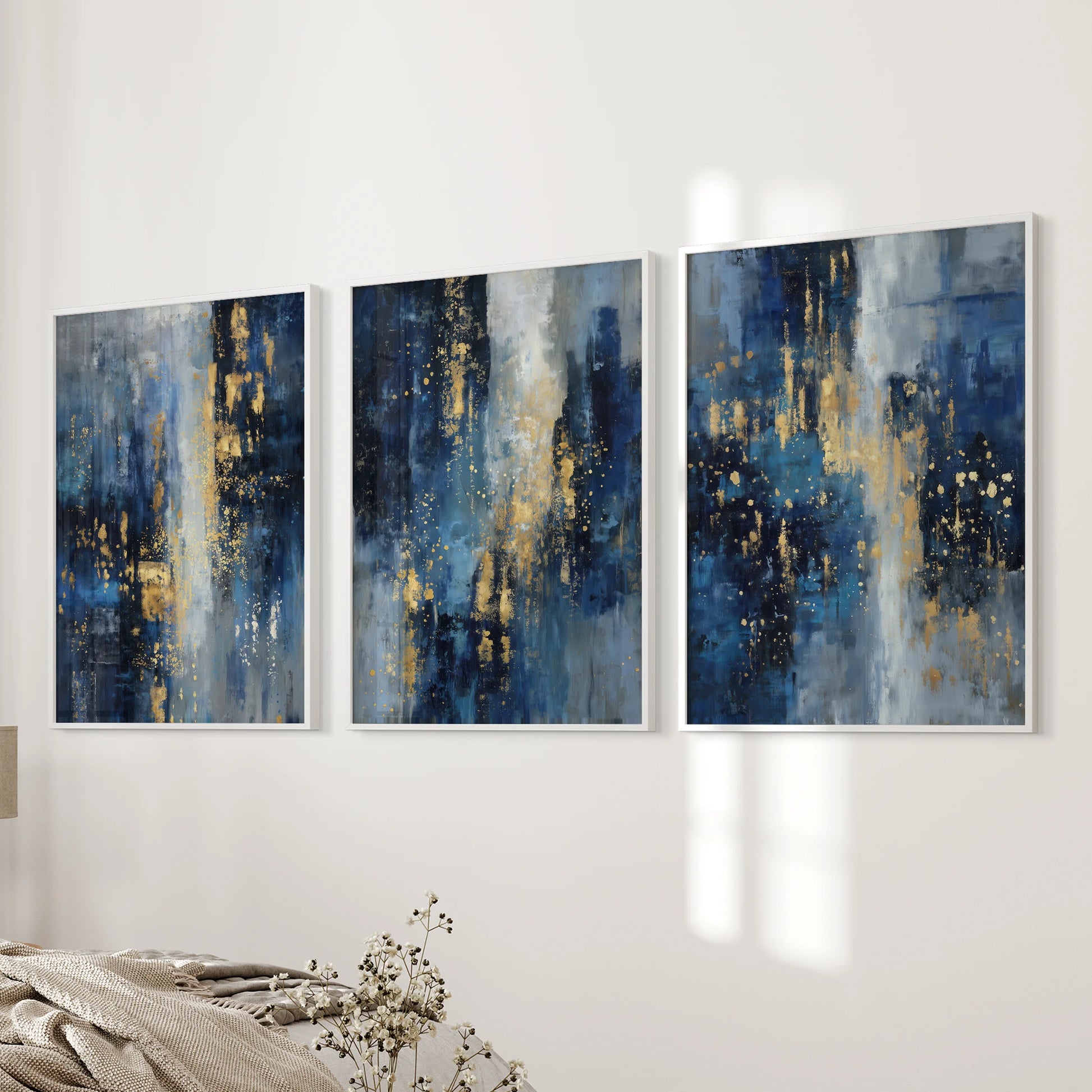 Gold sparkle accents on deep navy, 3-piece picture set, white-framed and hung beside the bed to add quiet shimmer to the bedroom.