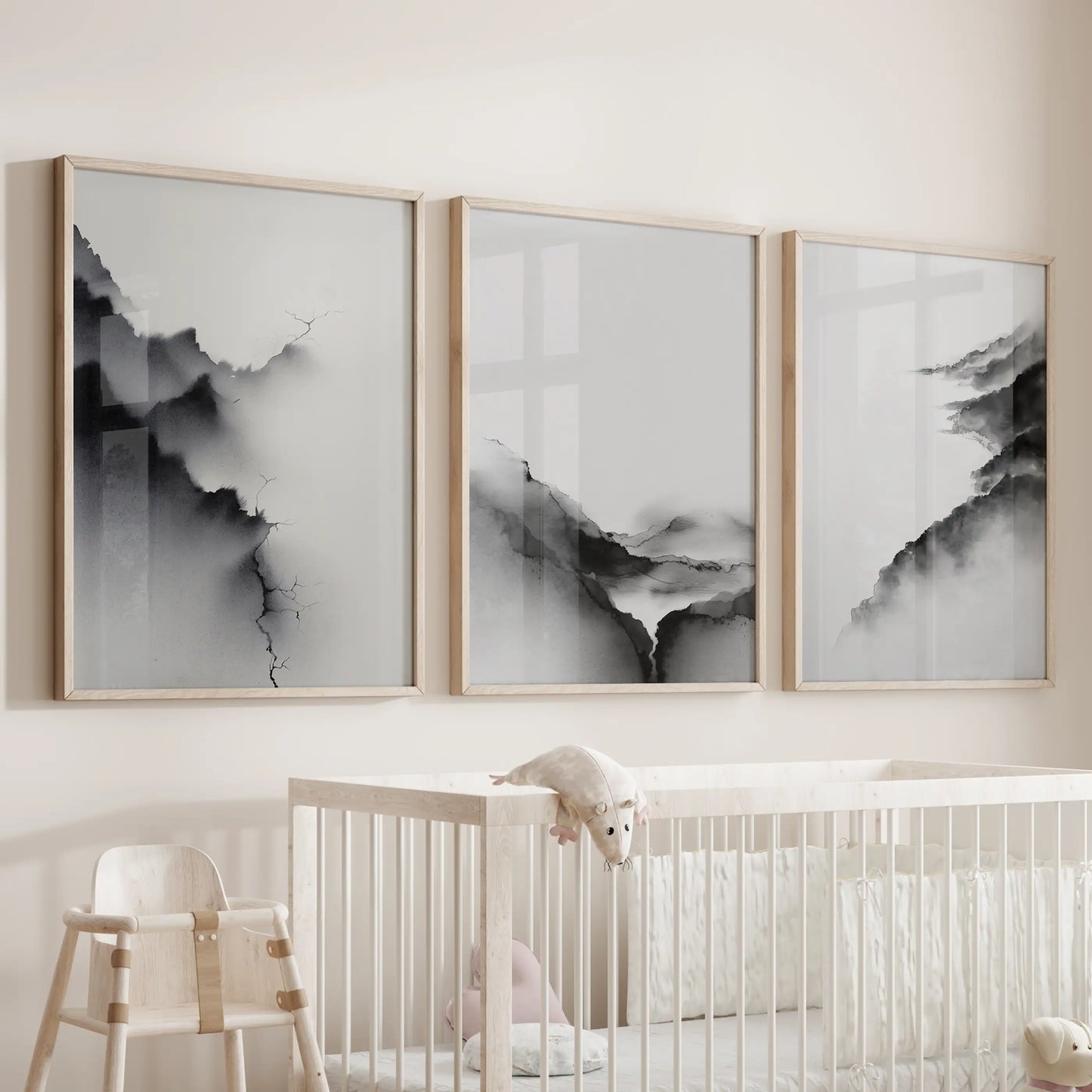 This three-panel wooden-framed wall print set of monochrome landscapes rests sweetly above the nursery cot.