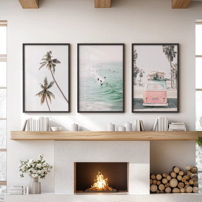 Three black-framed coastal prints featuring palm trees form a relaxed wall art trio above the living-room fireplace mantel.
