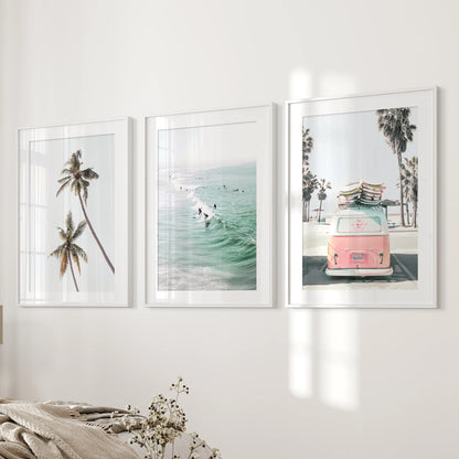 Ocean-surf wall art styled as a 3-print set soothes the bedroom, each white-matted frame evenly spaced along the feature wall.