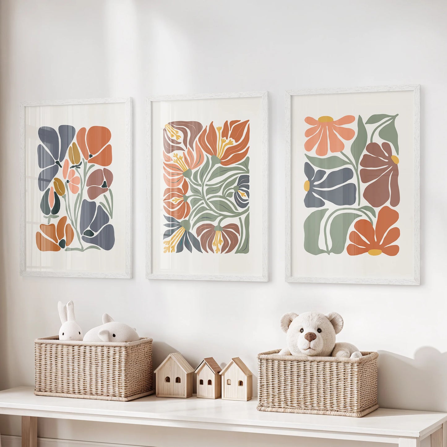 Abstract botanical florals, three art prints in white frames, brighten the kids’ room with friendly shapes and sunlit terracotta accents.