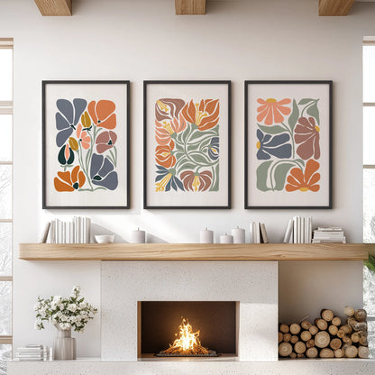 Terracotta flower market posters, set of three, in black frames warm a living room wall over the hearth with sun-baked tones and relaxed boho blooms.