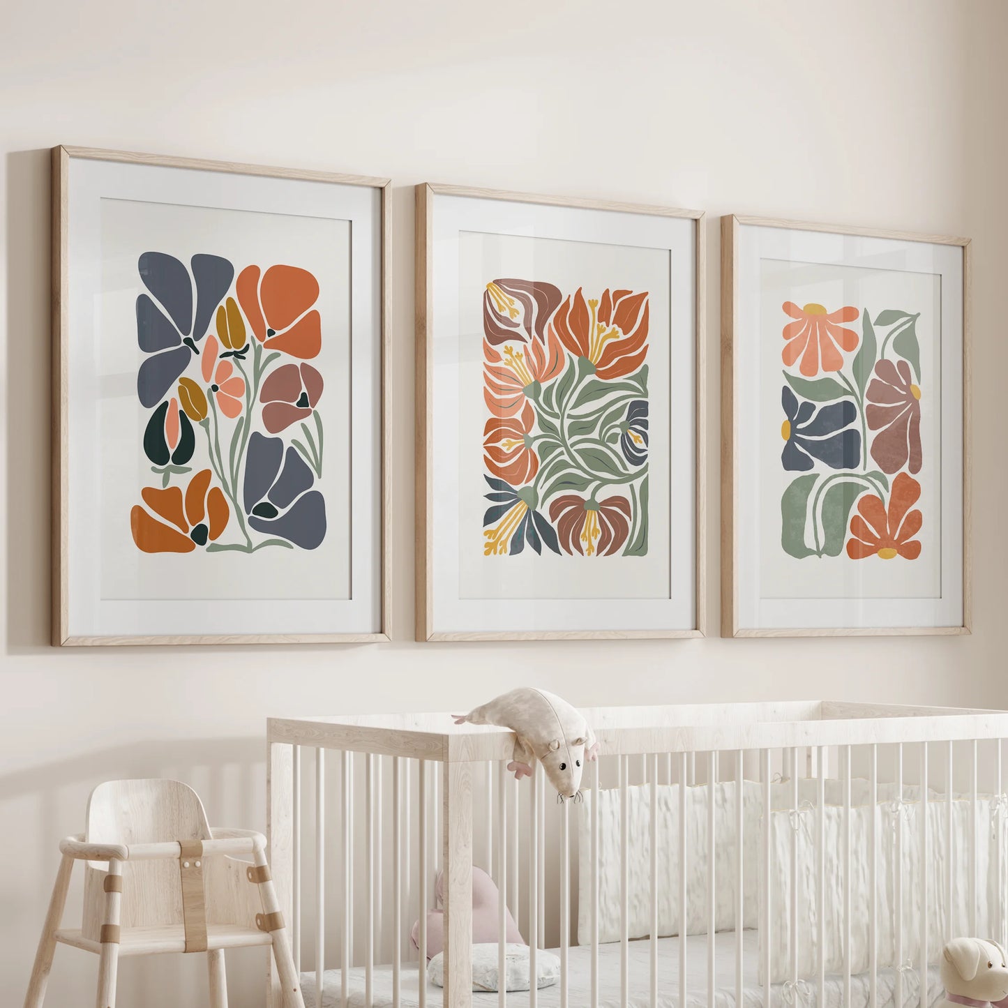 An oak-matted trio of vintage botanical prints lends the infant room gentle warmth, hanging sweetly above the crib.