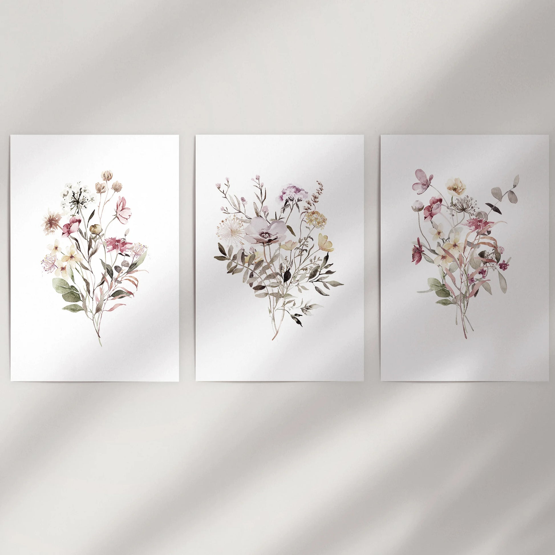 Wildflower bouquets, an unframed wall art set of 3, brings airy color to a blank wall with softly painted stems and petals.