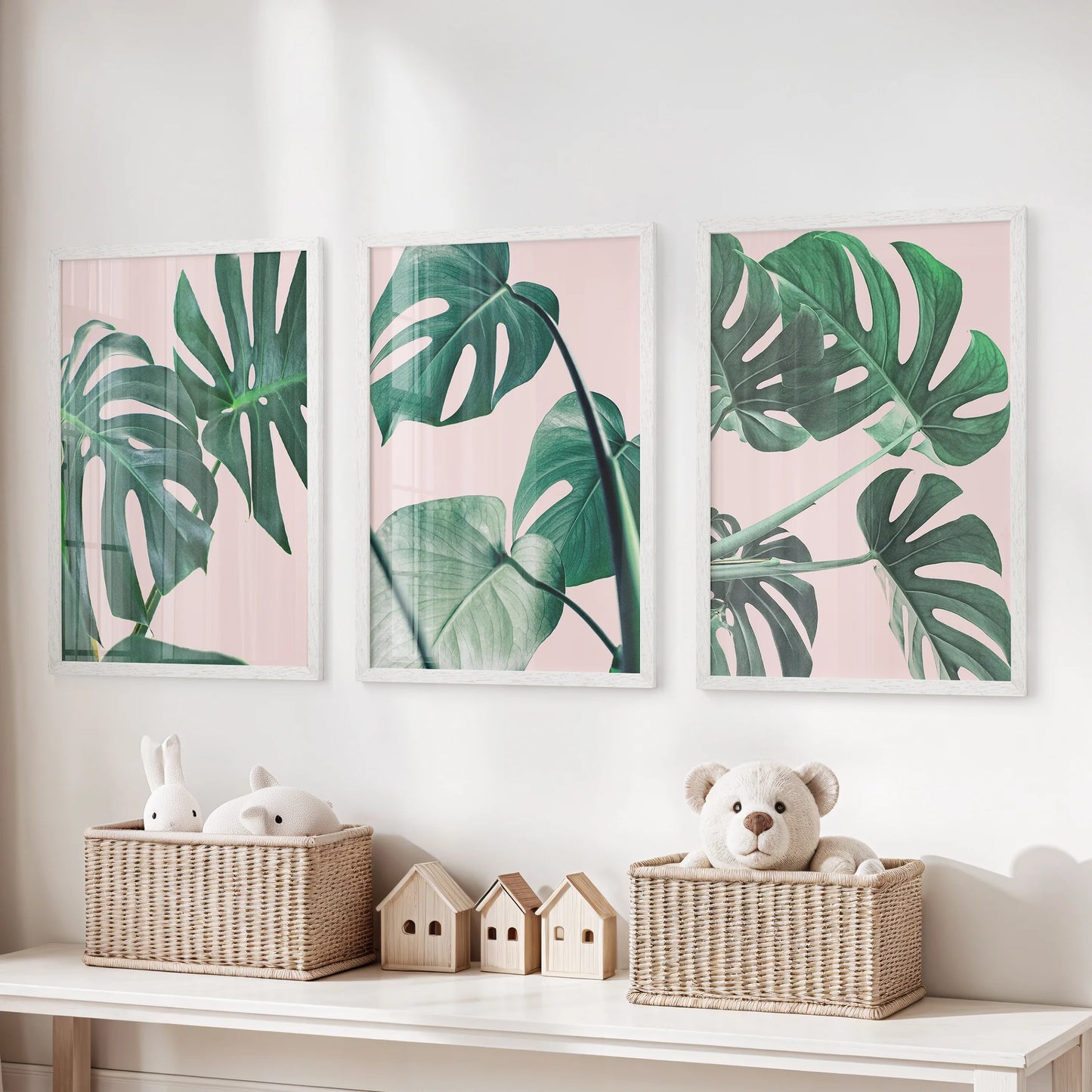 Monstera leaf close-ups gallery set of three white-framed prints makes playful yet tidy wall art for a children’s room, mixing blush pink with fresh greens.