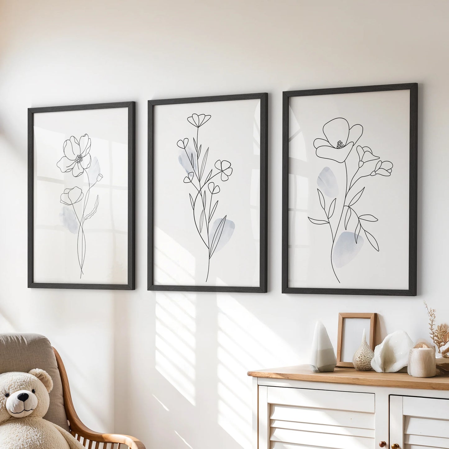A three-piece wall art set of fine botanical line drawings sits in black frames above the playroom dresser for a tidy, modern accent.