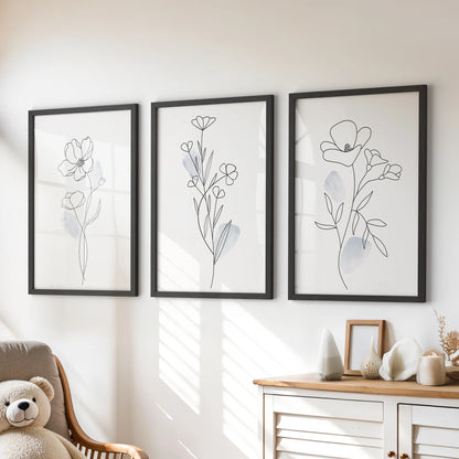 A three-piece wall art set of fine botanical line drawings sits in black frames above the playroom dresser for a tidy, modern accent.