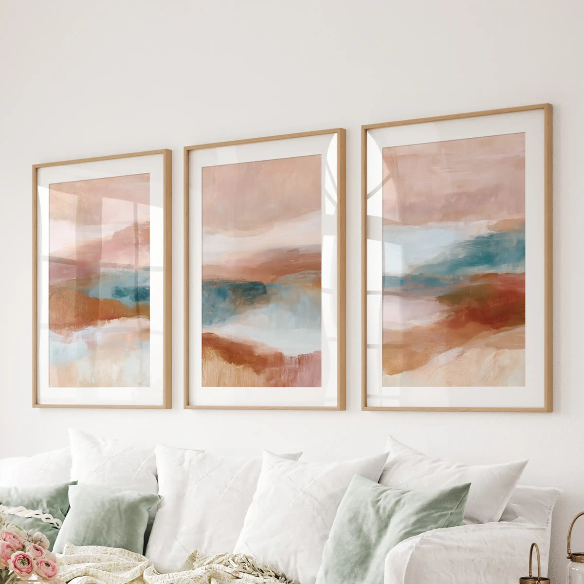 Organic abstract shapes, a 3-piece wall art series in natural wood frames with mats, arranges cleanly over the living room couch.