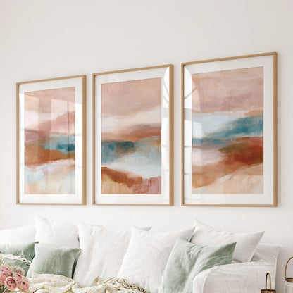 Organic abstract shapes, a 3-piece wall art series in natural wood frames with mats, arranges cleanly over the living room couch.