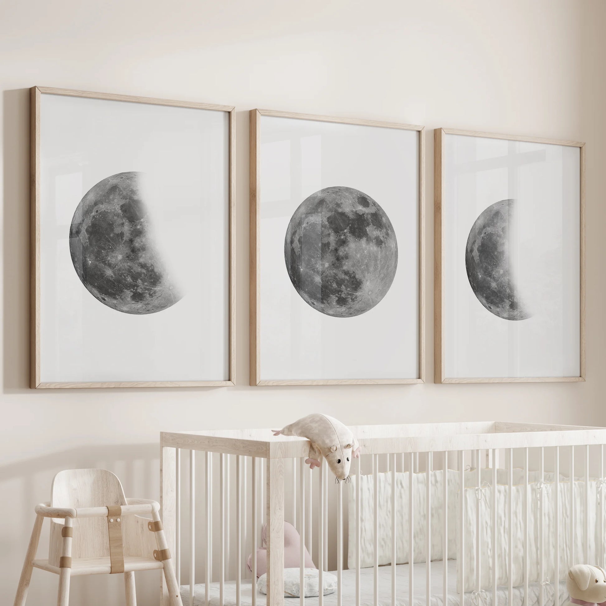 An oak-framed 3-piece moon art set drifts above the cot, adding soft lunar shapes to the infant room’s wall.