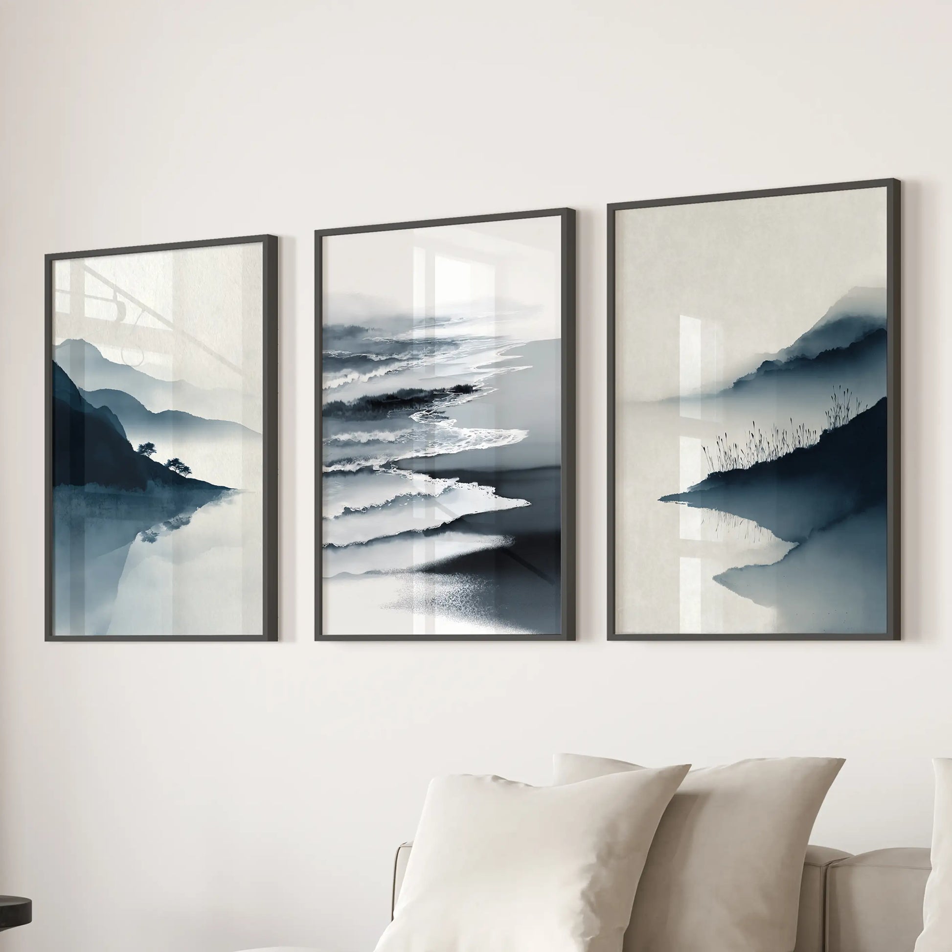 Minimalist shoreline triptych of three panels brings quiet focus above the sofa in the sitting room, finished as black-framed prints.