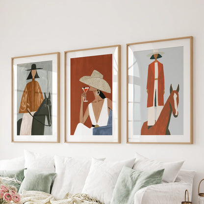 Horse and rider scenes, a set of three art prints in wooden frames with mats, span the family room above the sofa in classic ranch style.