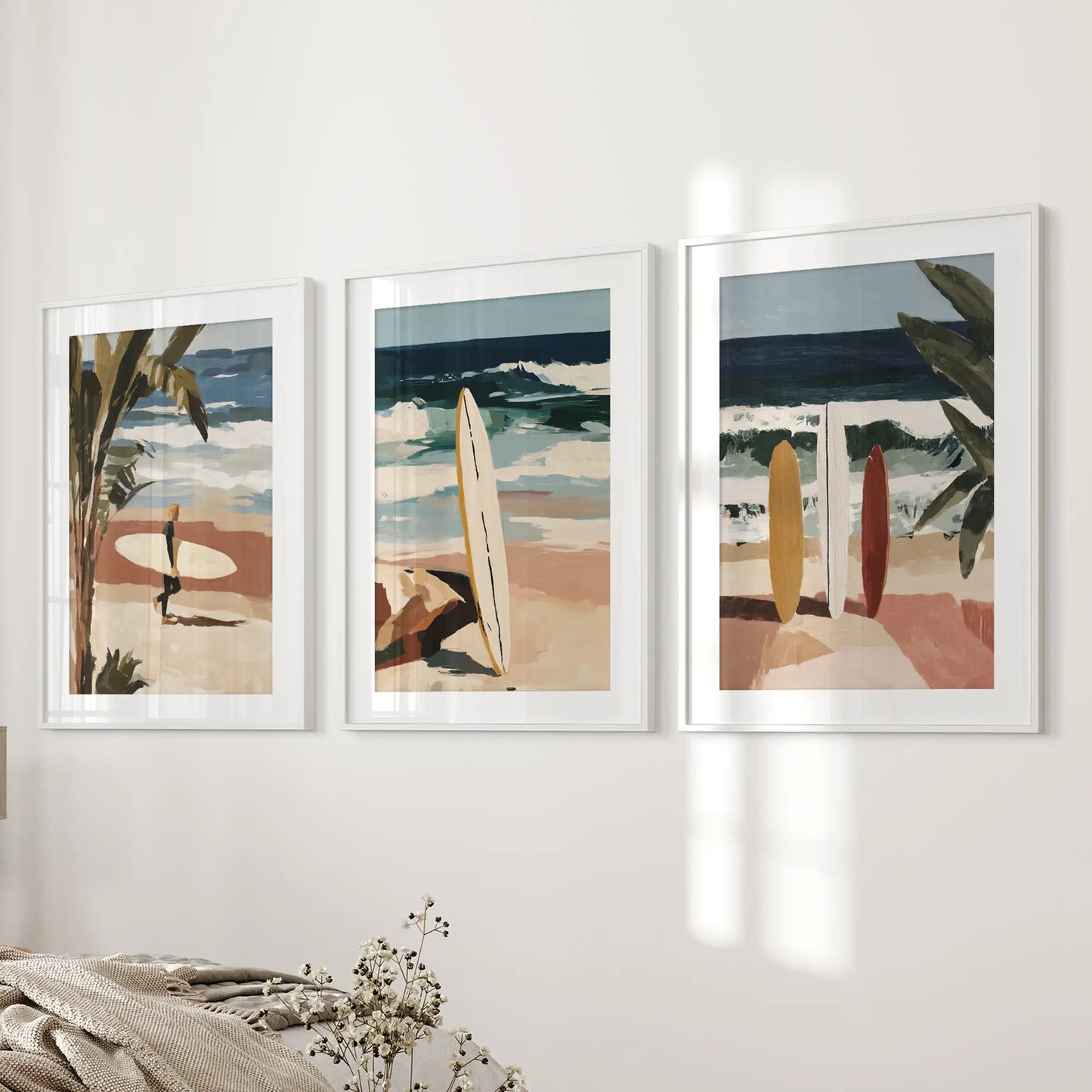 An ocean-wave wall art trio in white mat frames anchors the bedroom wall, rolling calm sea blues into a serene, modern retreat.