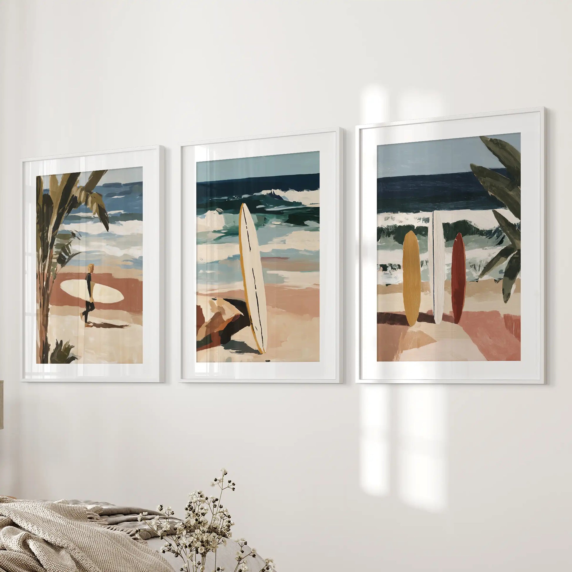 An ocean-wave wall art trio in white mat frames anchors the bedroom wall, rolling calm sea blues into a serene, modern retreat.