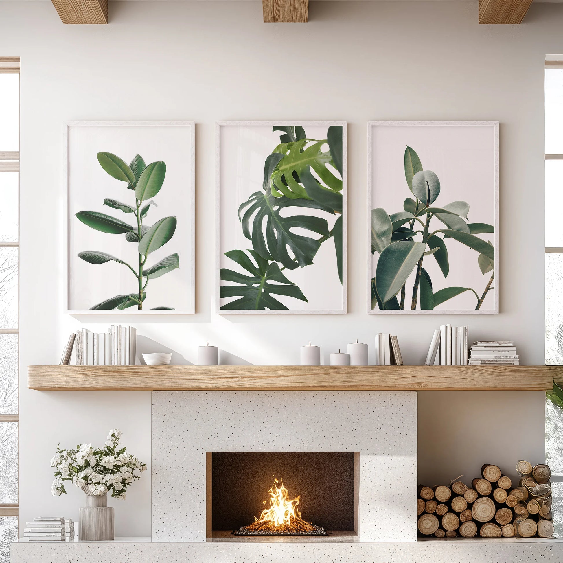 Rubber plant leaves, a set-of-3 wall art arrangement in bright white frames, anchors the sitting room, poised above the hearth with bold, sculptural greens.