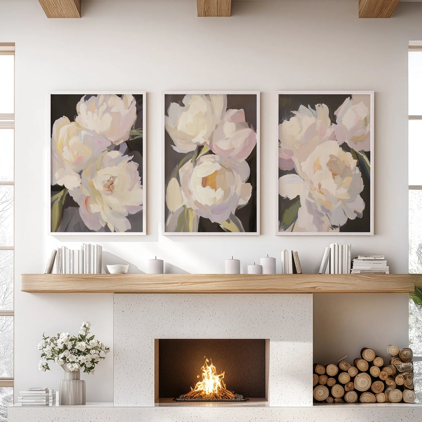 A set of three floral posters in slim white frames sits above the living room mantel, their inky tones warming the space with rich blooms.