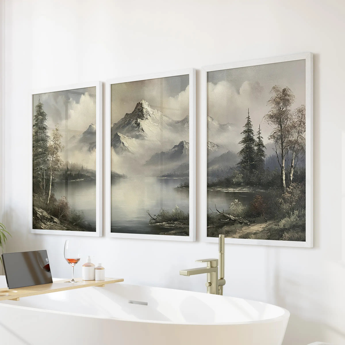 Moody mountain lake three-piece wall art in white frames, displayed over a freestanding tub in a bathroom.