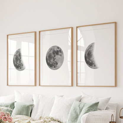 Lunar cycle trio 3-piece art wall, matted in oak frames, lines the wall behind the couch to ground the family room with calm, modern moon art.