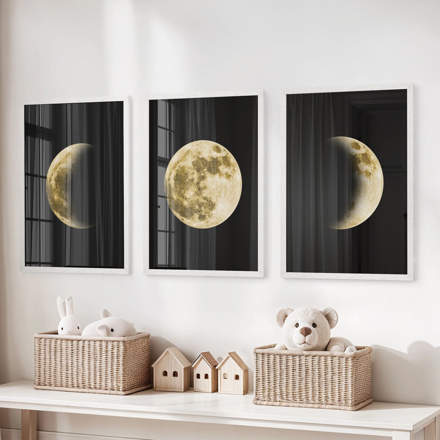 A three-print wall set of moon surfaces in white frames brings quiet wonder and bright ease to a child’s room decor.