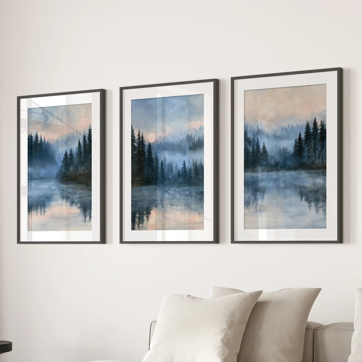 Three moonlit blue landscape wall prints, matted in black frames, float above the sectional and give the living room a hushed nighttime glow.