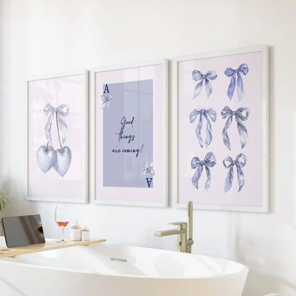 Good Things Are Coming typography wall art, three-print set, glows in white frames over the tub wall, lending calm encouragement to a bright bathroom.