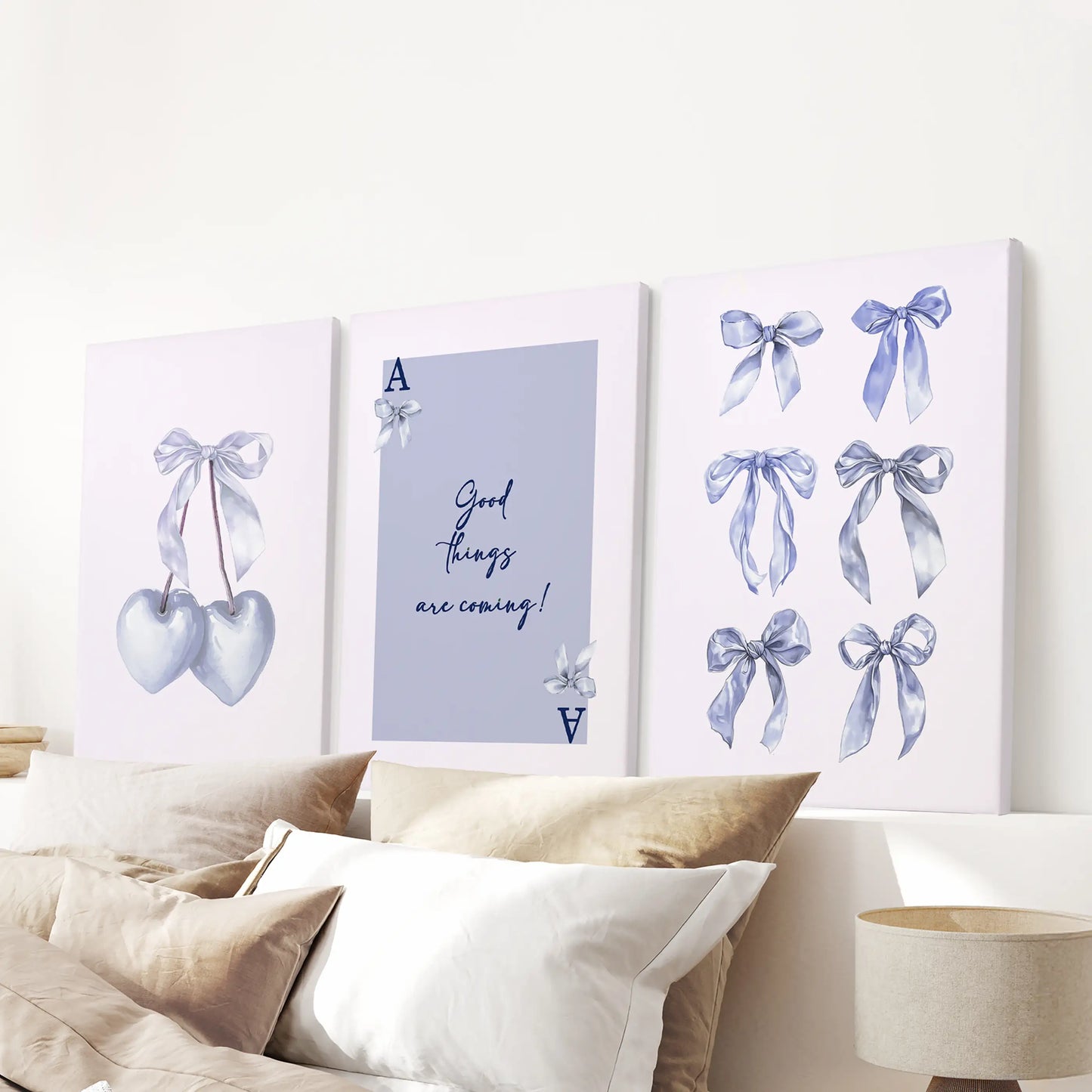 Above the bed headboard hangs a three-piece Good Things Are Coming canvas set, soft blue tones wrapping the room in optimism.