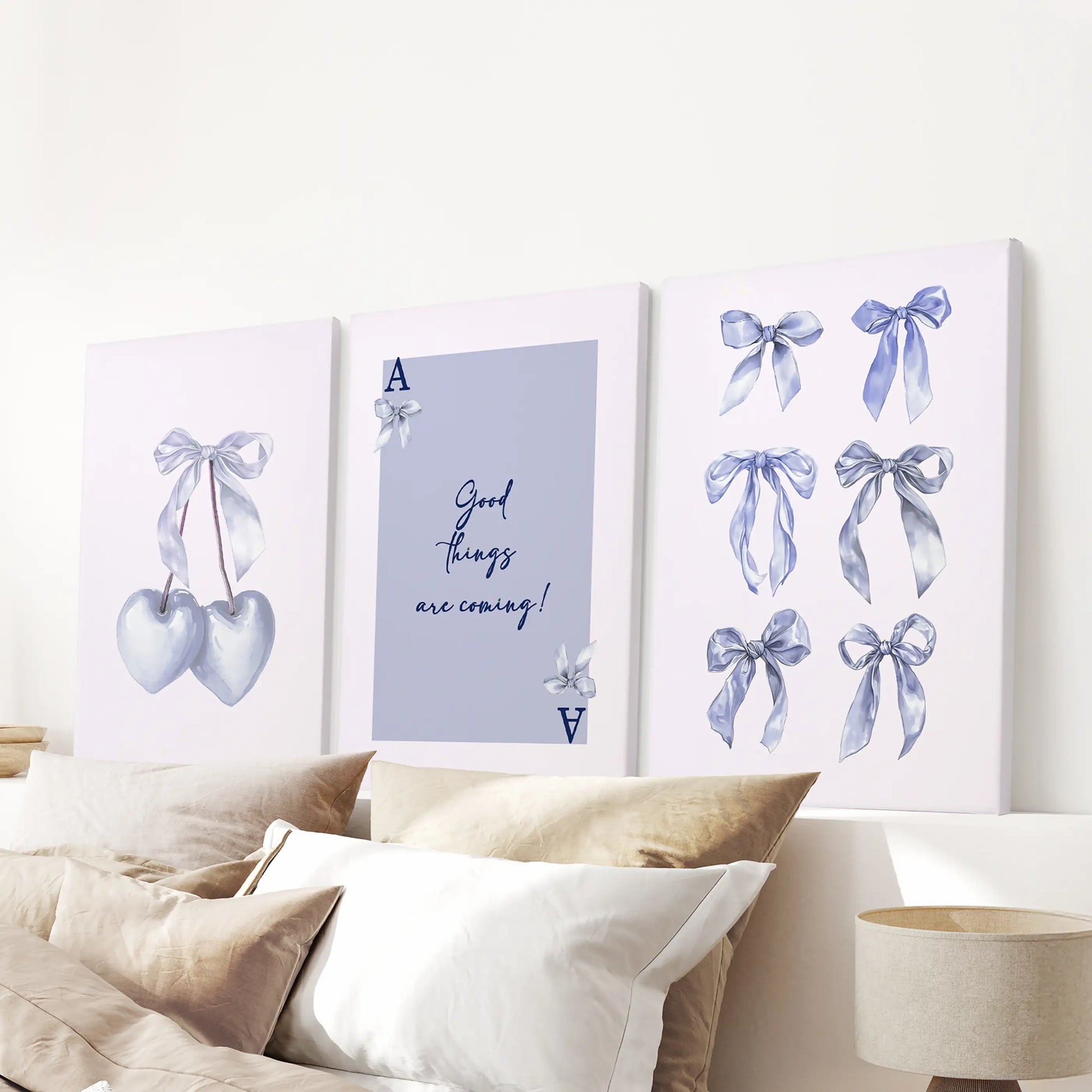 Above the bed headboard hangs a three-piece Good Things Are Coming canvas set, soft blue tones wrapping the room in optimism.