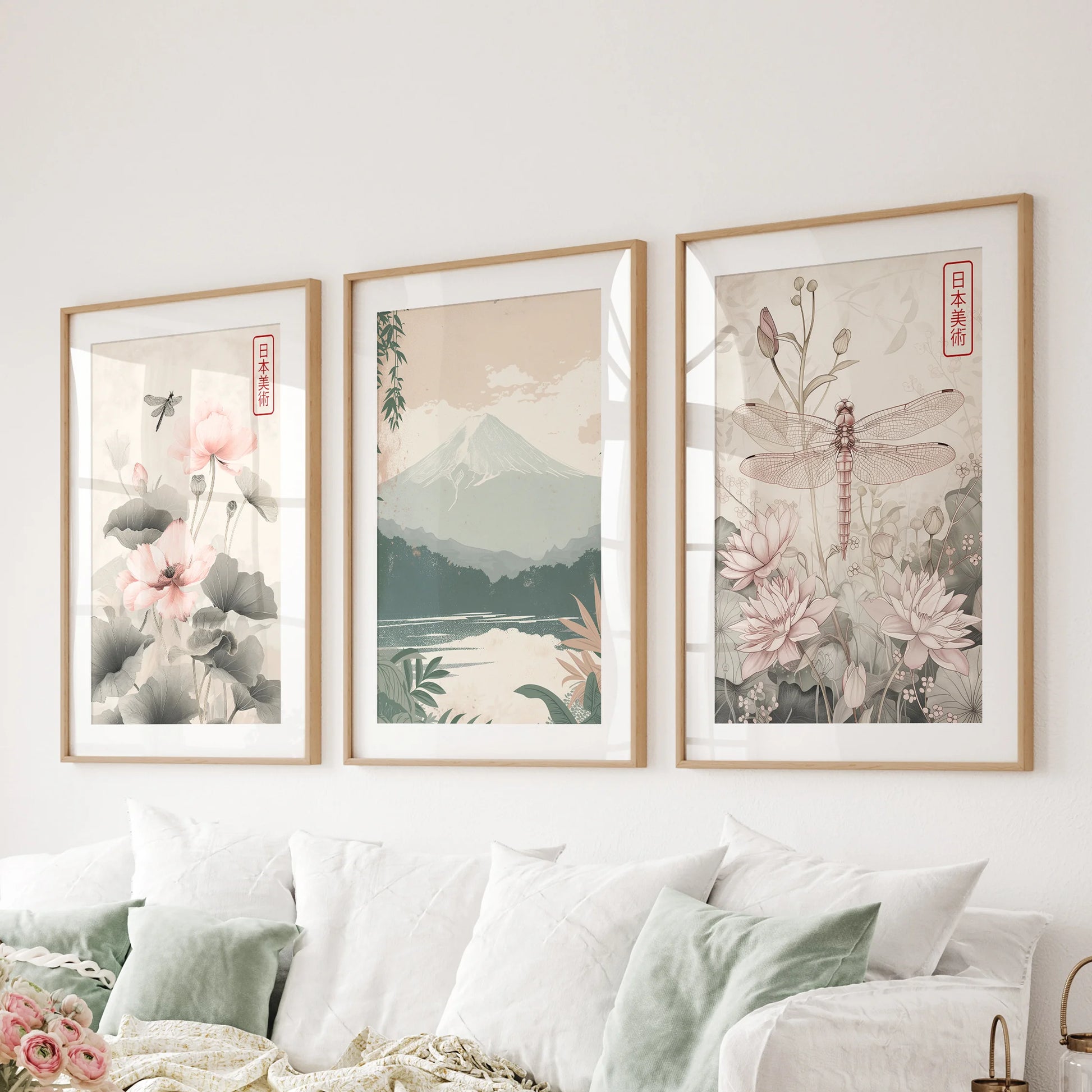 Mount Fuji landscape set of three posters in solid oak frames with mats, spanning the living room wall above the sectional for a serene horizon.