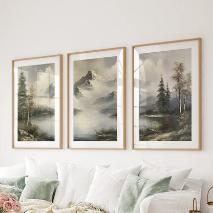 Three-poster wall art set featuring mountain cabin landscapes in natural wood frames with mats, displayed over a sitting room sectional.