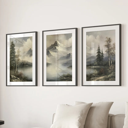 Muted alpine scenery set of three wall art prints in black frames with mats, arranged over a sectional in a family room.
