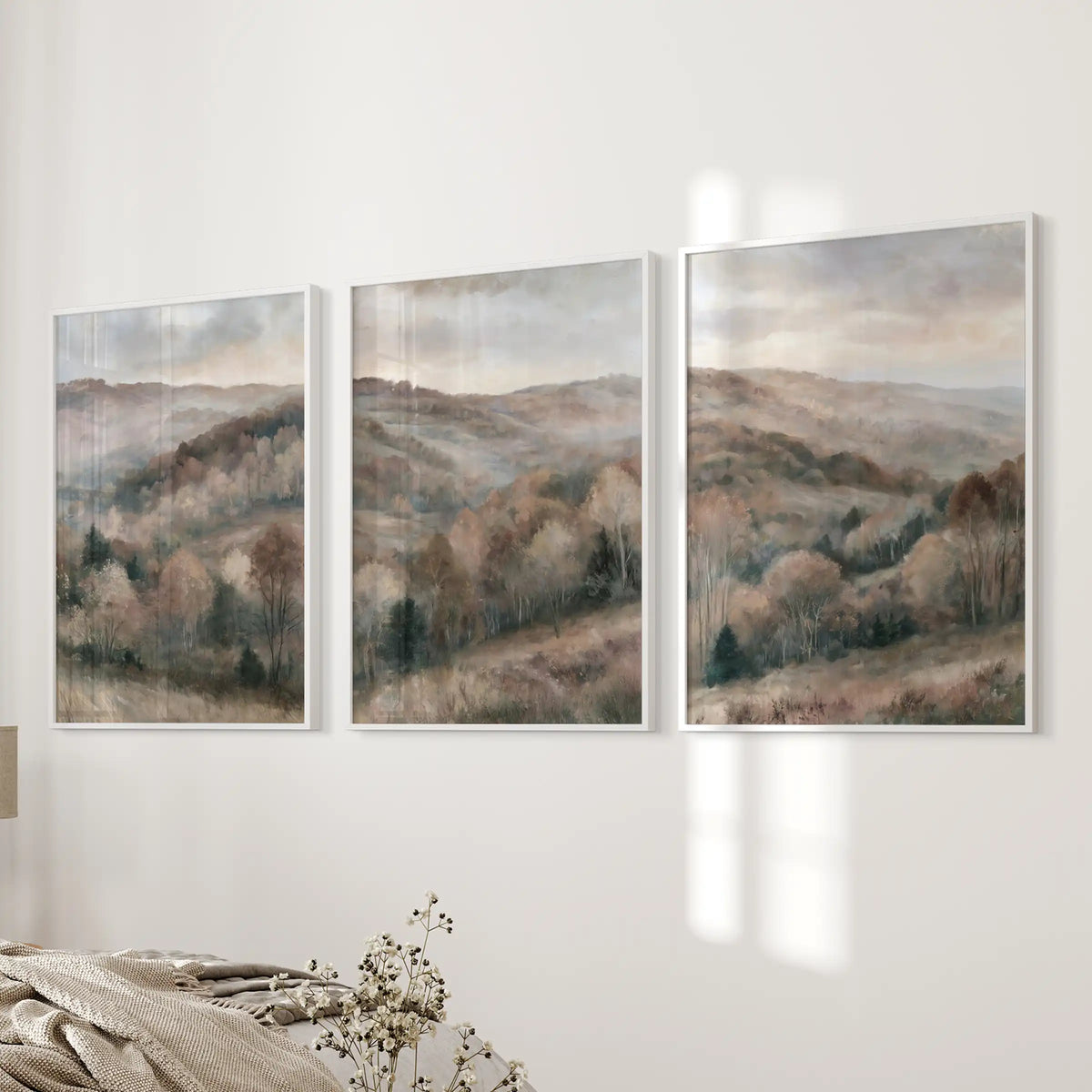 Soft watercolor woods wall art, a trio, brightens the bedside wall with clean white frames, bringing a hush of nature into the bedroom.