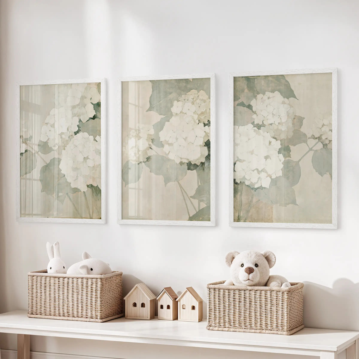 Three-piece wall print set of soft white flowers in white frames, hanging over a toy organizer in a kids' playroom.