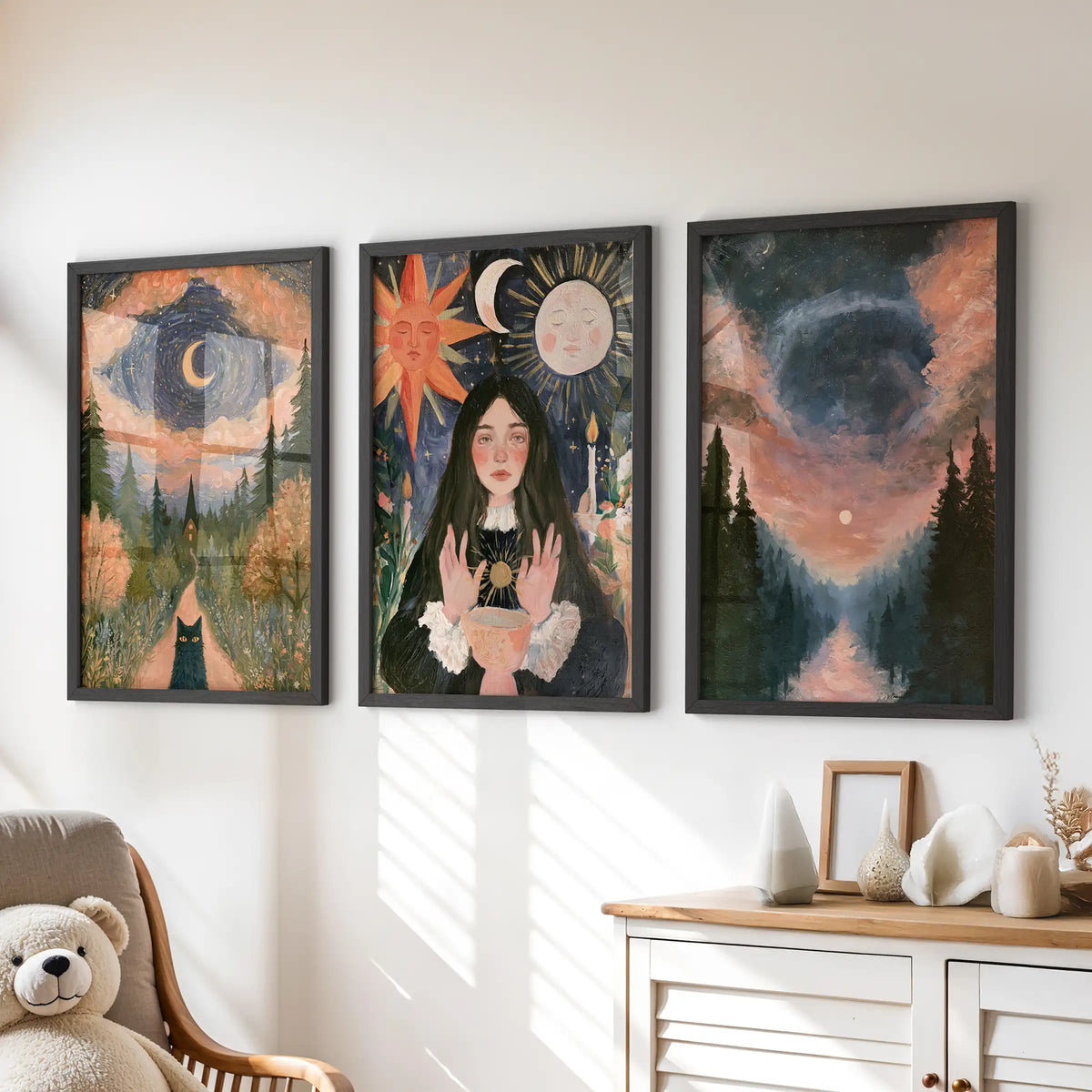 A three-piece celestial forest wall hanging in black frames sits over the kids-room dresser, pairing moonlit trees with gentle magic.