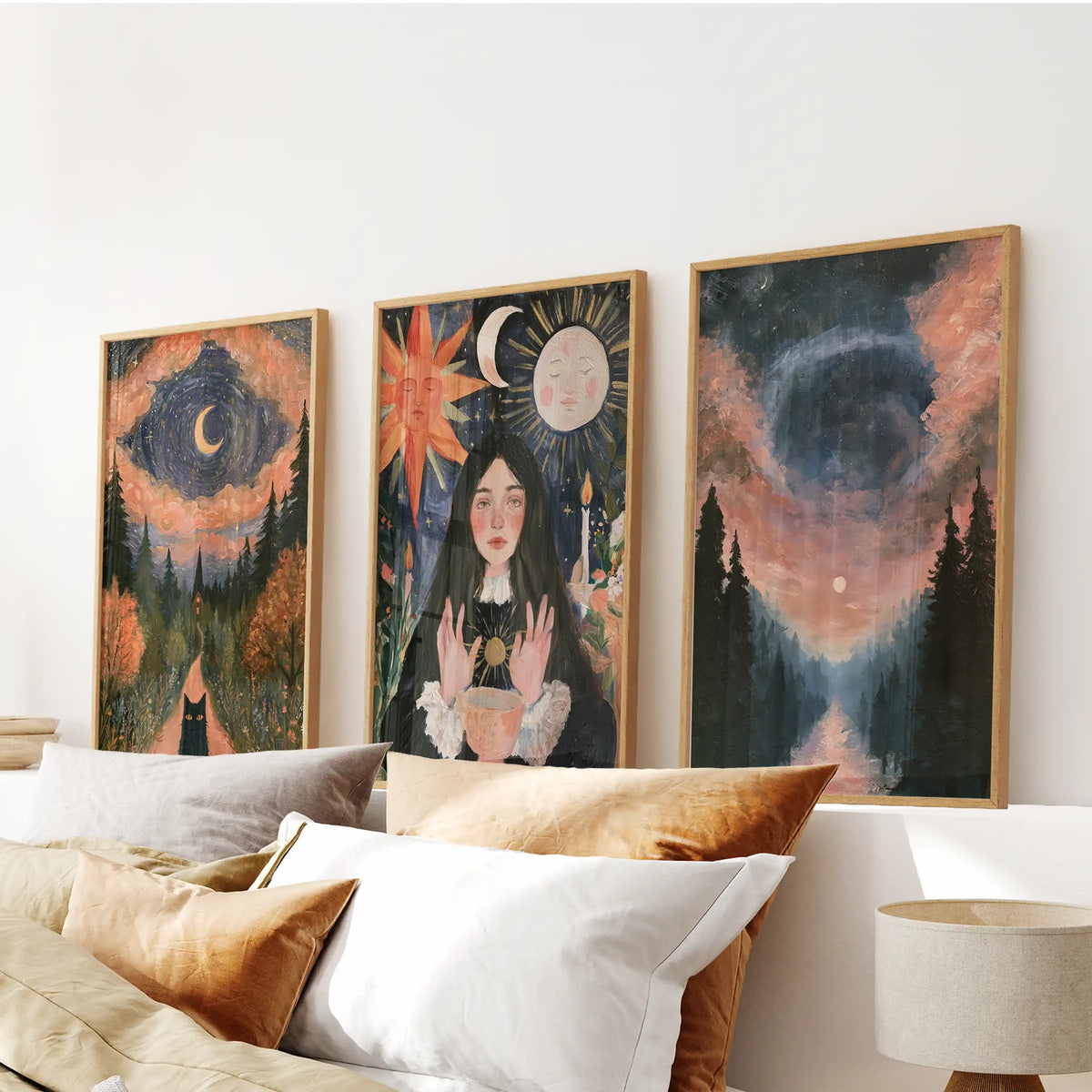 A set of three celestial moon-and-sun wall art pieces in wooden frames hovers above the bedroom headboard, balancing dusky tones and radiant highlights.