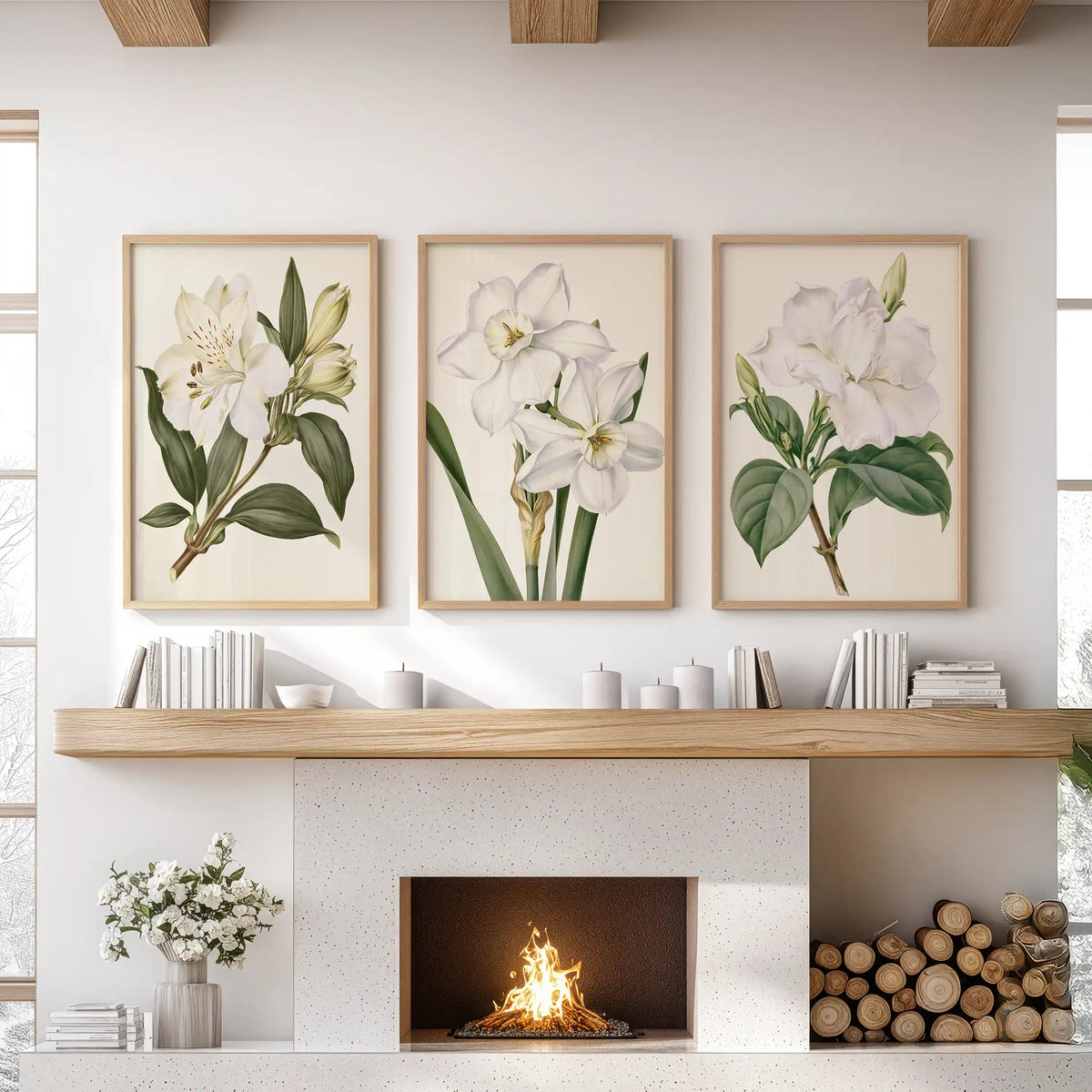 A set of three white botanical flower prints in oak frames above a fireplace.