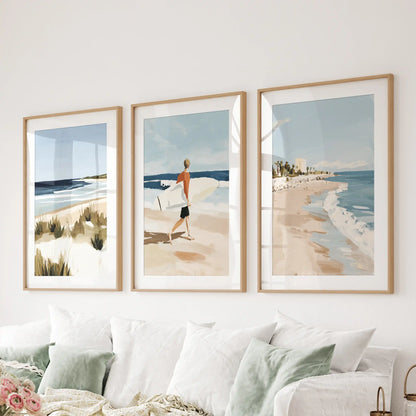 A set of three light-wood matted surf pictures spans the wall above the sitting-room sectional, adding gentle coastal rhythm.