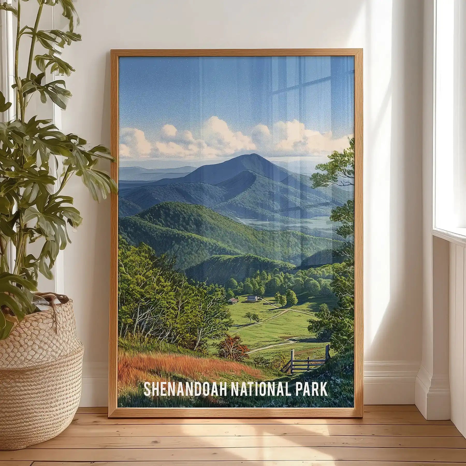 Blue Ridge Mountains artwork print in a thin wood frame leans on the bedroom floor against the wall, adding warm timber tones to the serene scene.