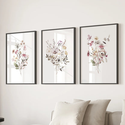Three black-framed wildflower art prints create soothing wall decor above the sectional, adding soft watercolor color to the cozy sitting room.
