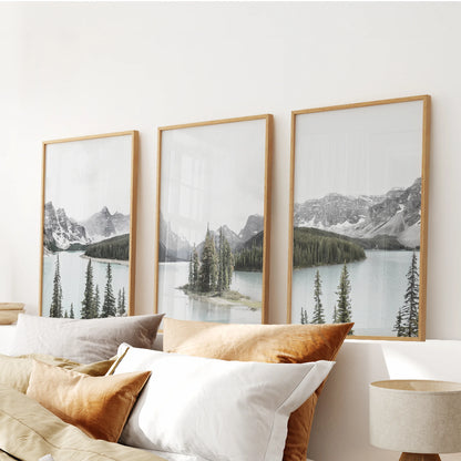 A 3-piece wall art collection of mountain lake and forest in warm oak frames centers above the headboard, grounding the bedroom in natural texture.