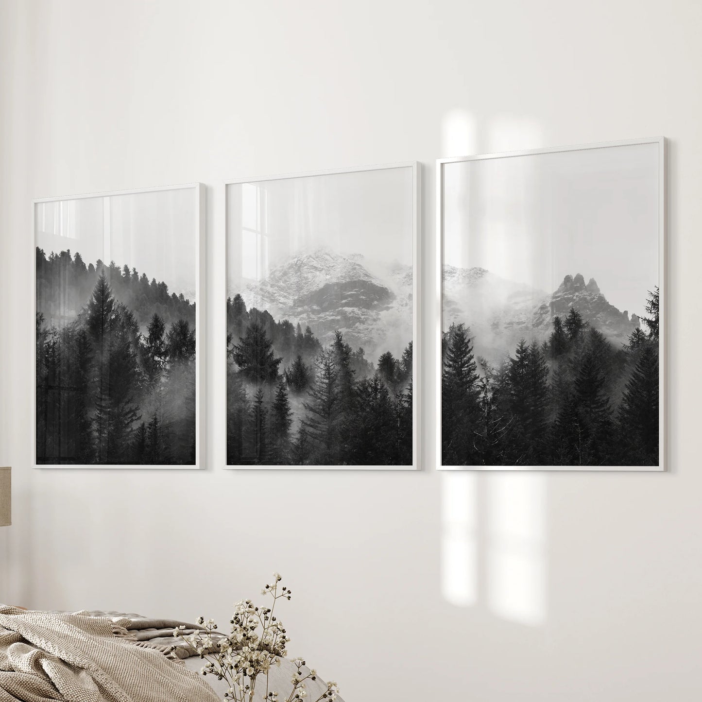 Fog-washed pine trees appear across this three-piece wall art set in white frames, a peaceful companion beside the bed.