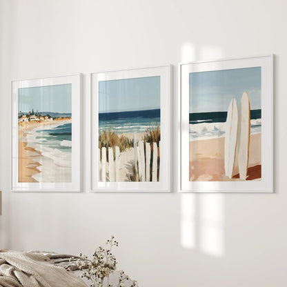 Surfboards on the beach print trio brings easy surf energy to the bedroom, mounted along the wall beside the bed in white frames with a wide mat.