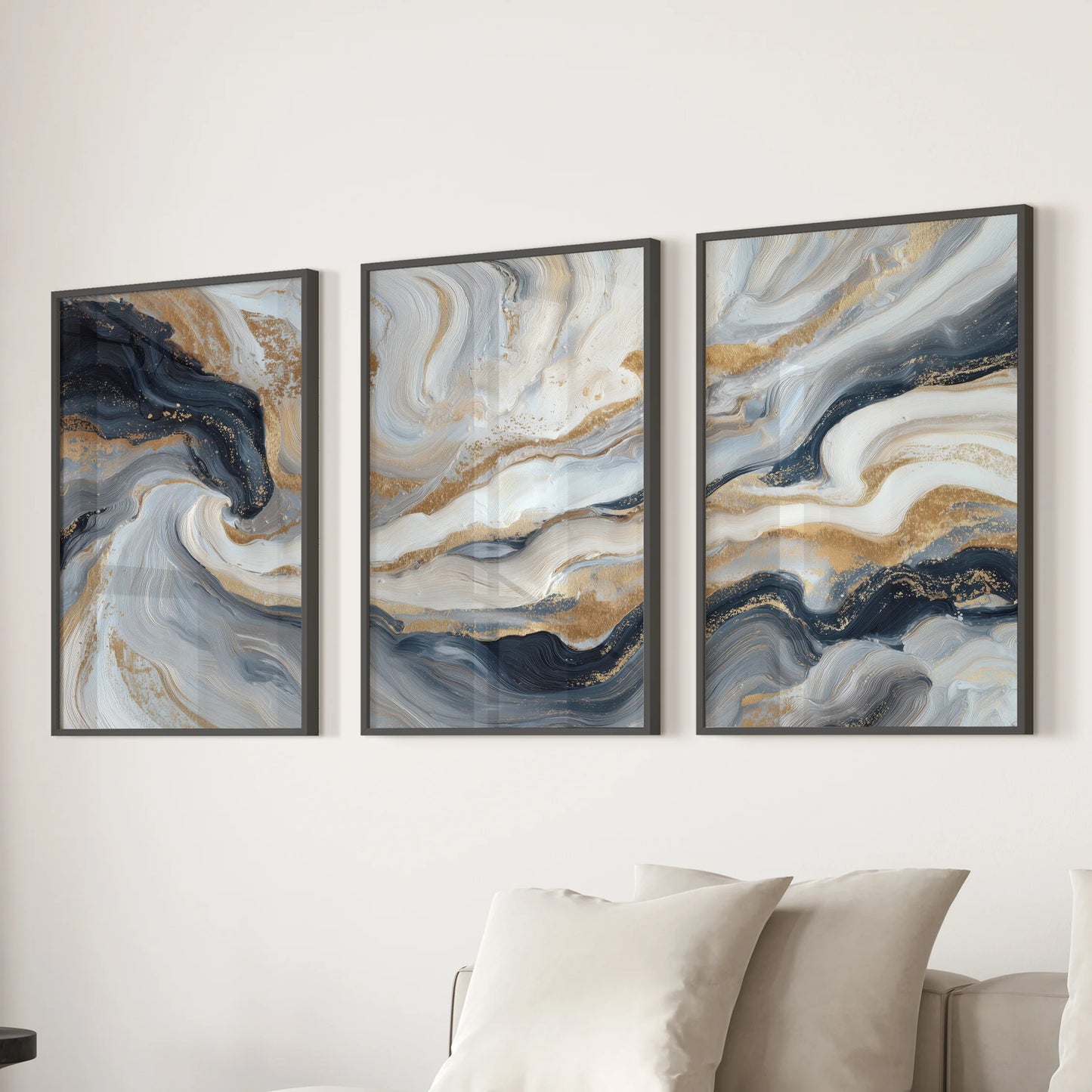 Set of three blue and gold abstract art prints, simply framed in black, gives the lounge wall a sleek, minimal balance above the sofa.