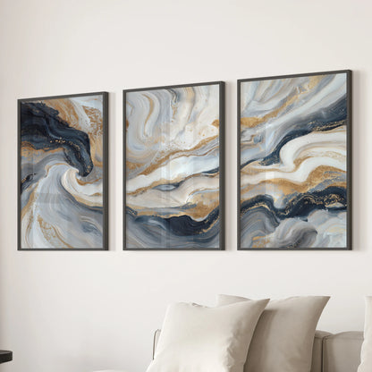 Set of three blue and gold abstract art prints, simply framed in black, gives the lounge wall a sleek, minimal balance above the sofa.
