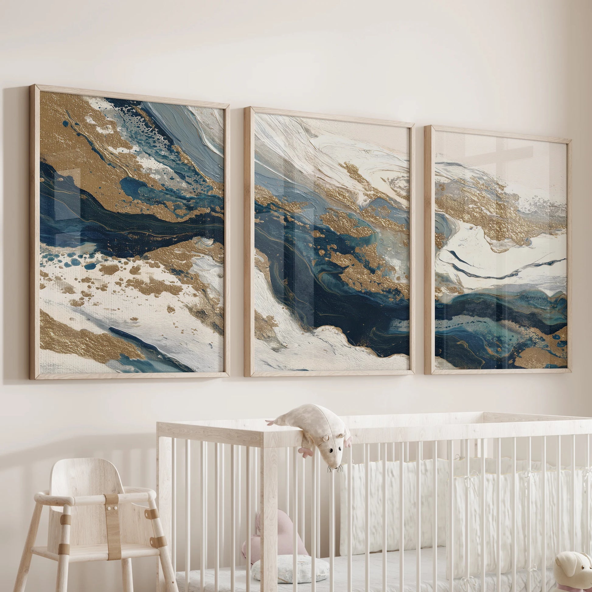 Wood-framed trio of navy and gold abstract prints hangs above the baby’s cot, adding soothing color with a modern, airy profile.