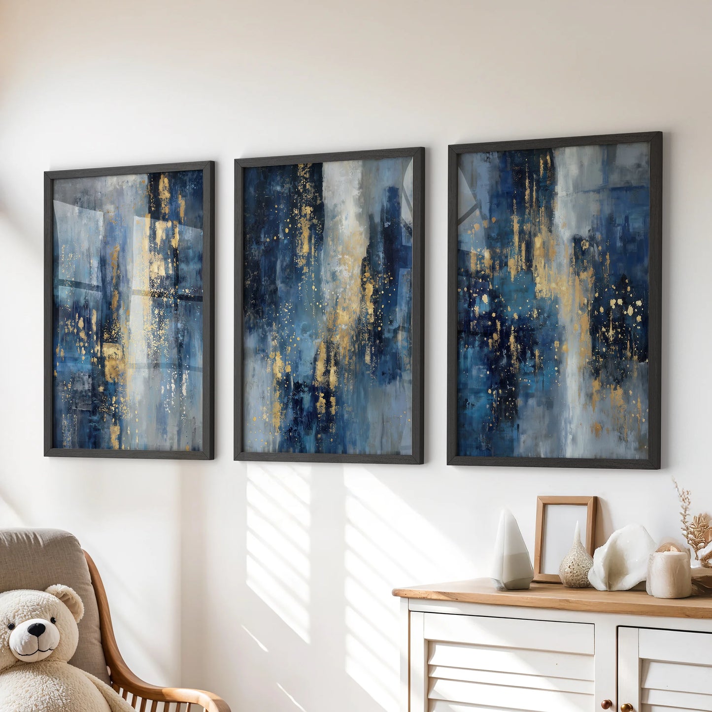 Black-framed blue and gold triptych wall art brightens a kids playroom, positioned neatly above the dresser for a crisp, modern look.