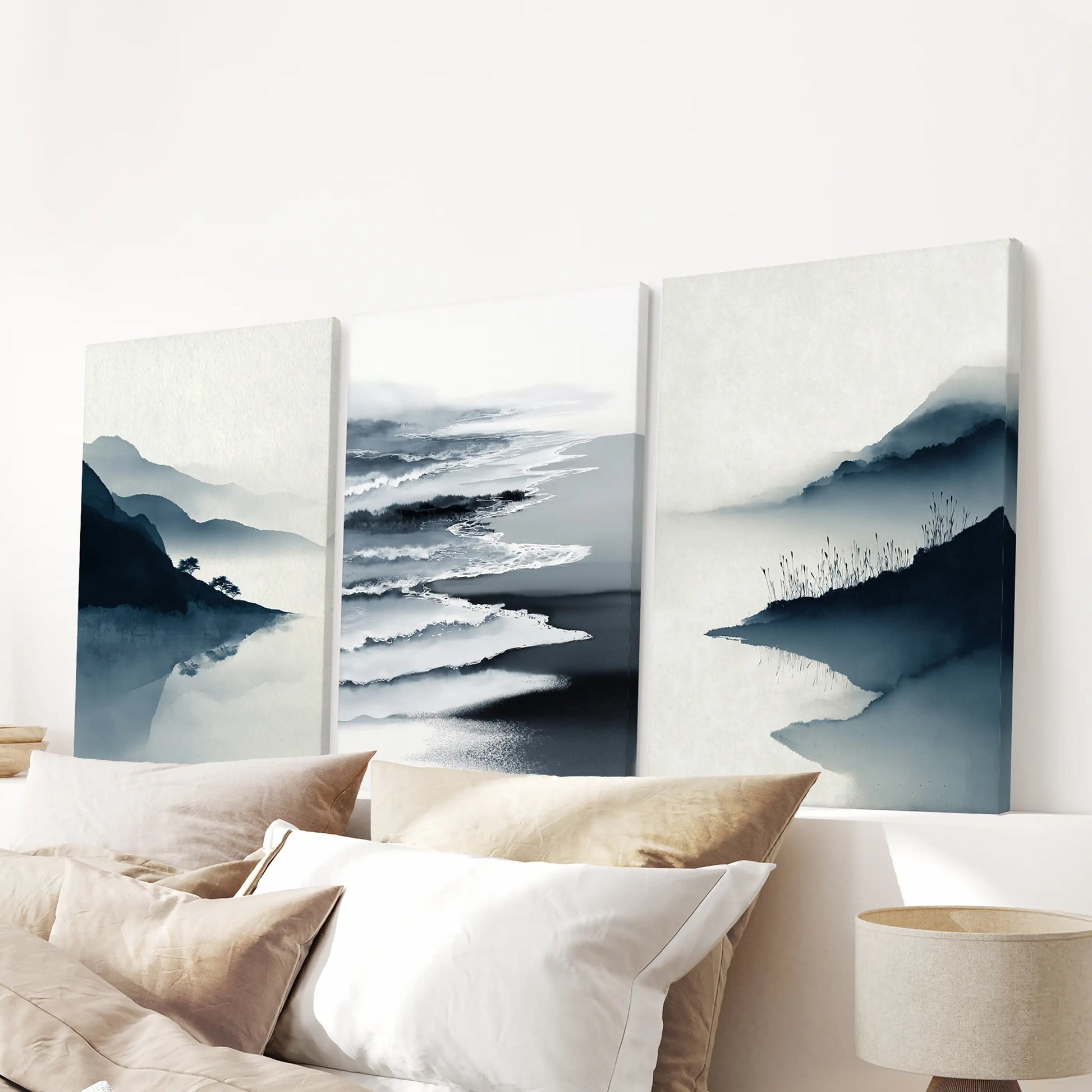 Three wrapped-canvas seascape pieces hang above the bed, their clean edges bringing a smooth, serene finish to the bedroom wall.