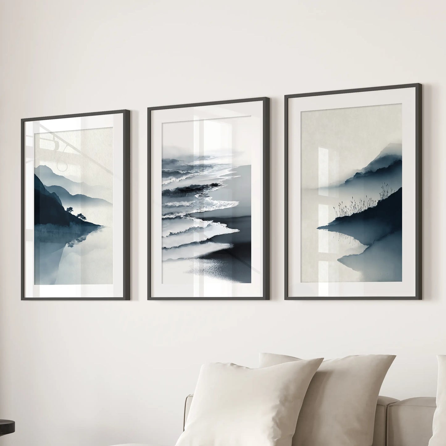Navy ocean seascape prints, a 3-piece wall art set, stretch across the sitting room behind the couch in black mat frames.