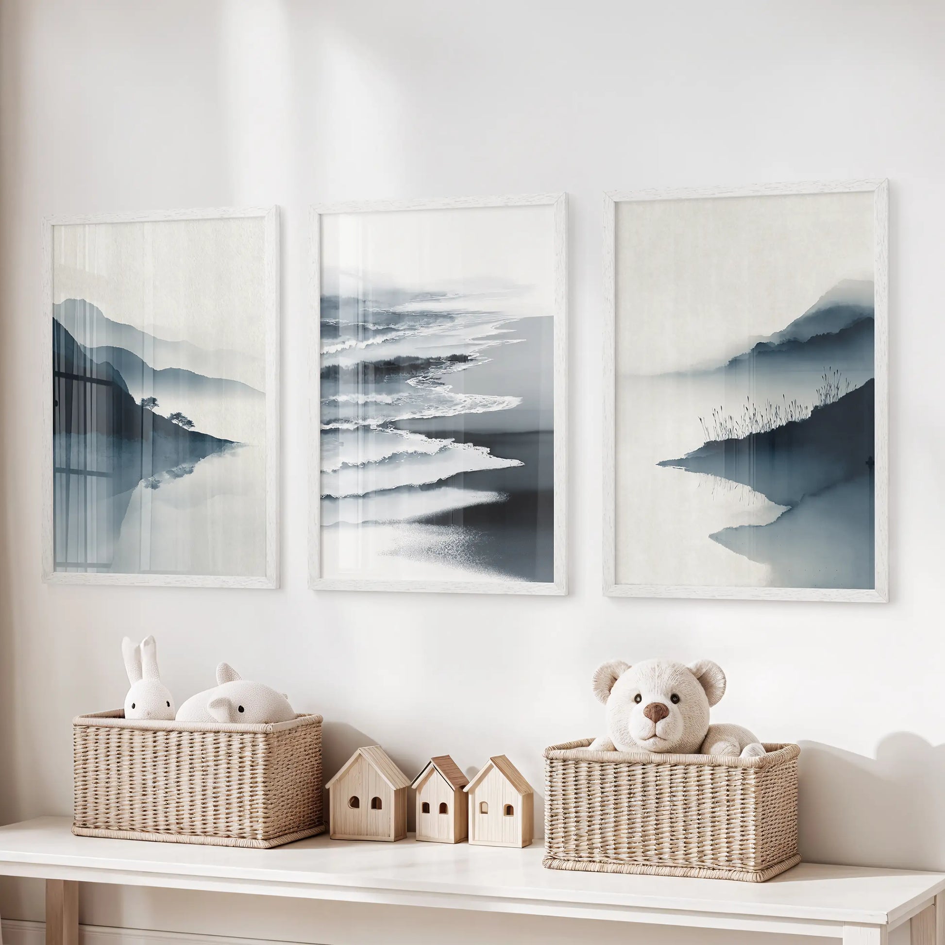 Three white-framed minimalist shoreline prints float above the toy bench in the children’s room, adding airy coastal calm.