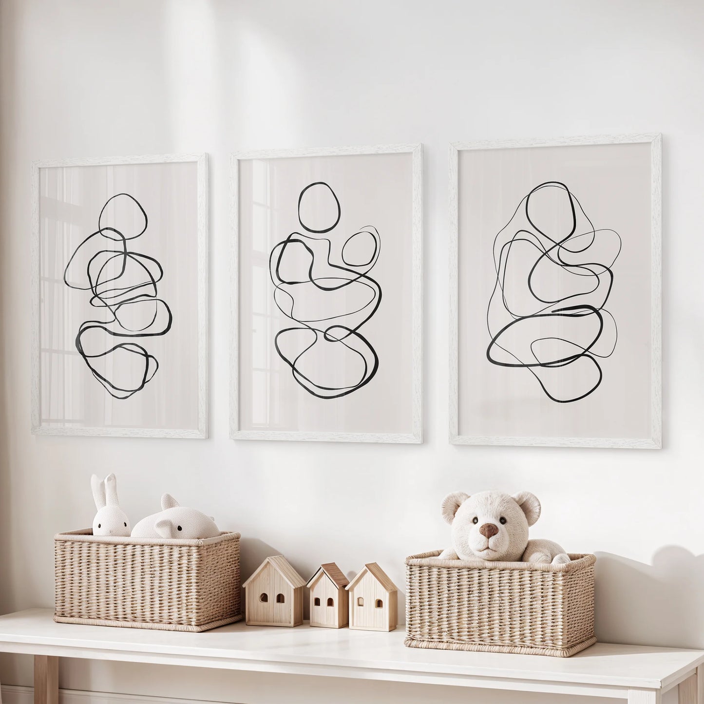 One-line drawings, a 3-piece art print set, sit white framed above the toy organizer, adding tidy graphic wall art to the playroom.