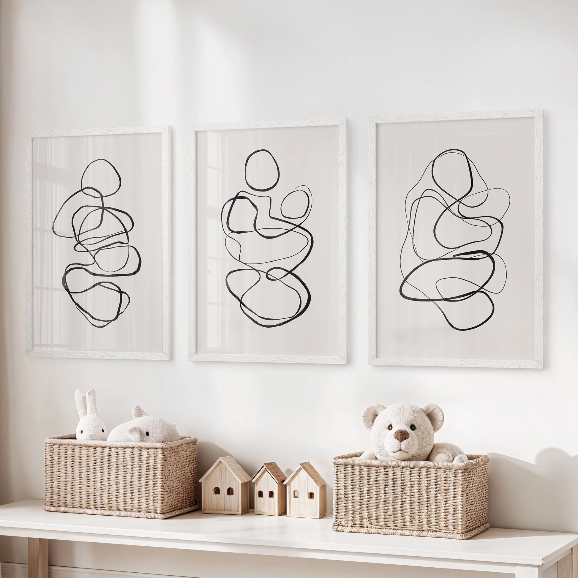 One-line drawings, a 3-piece art print set, sit white framed above the toy organizer, adding tidy graphic wall art to the playroom.